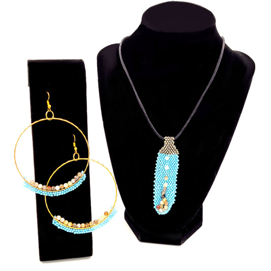 Necklace of blue and brown seed beads and gold tone hoop earrings on black velvet displays.