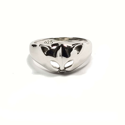 Silver ring with a cat face and ears. The eyes are cut outs of the metal. The ring is tapered down to the sides from the cat head. The inside of the band is stamped with "925."