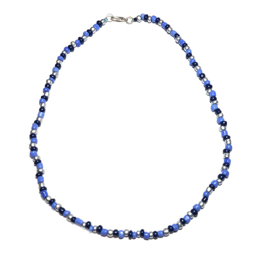 Single strand necklace made with sky blue, navy blue, and silver beads. Silver colored lobster clasp.