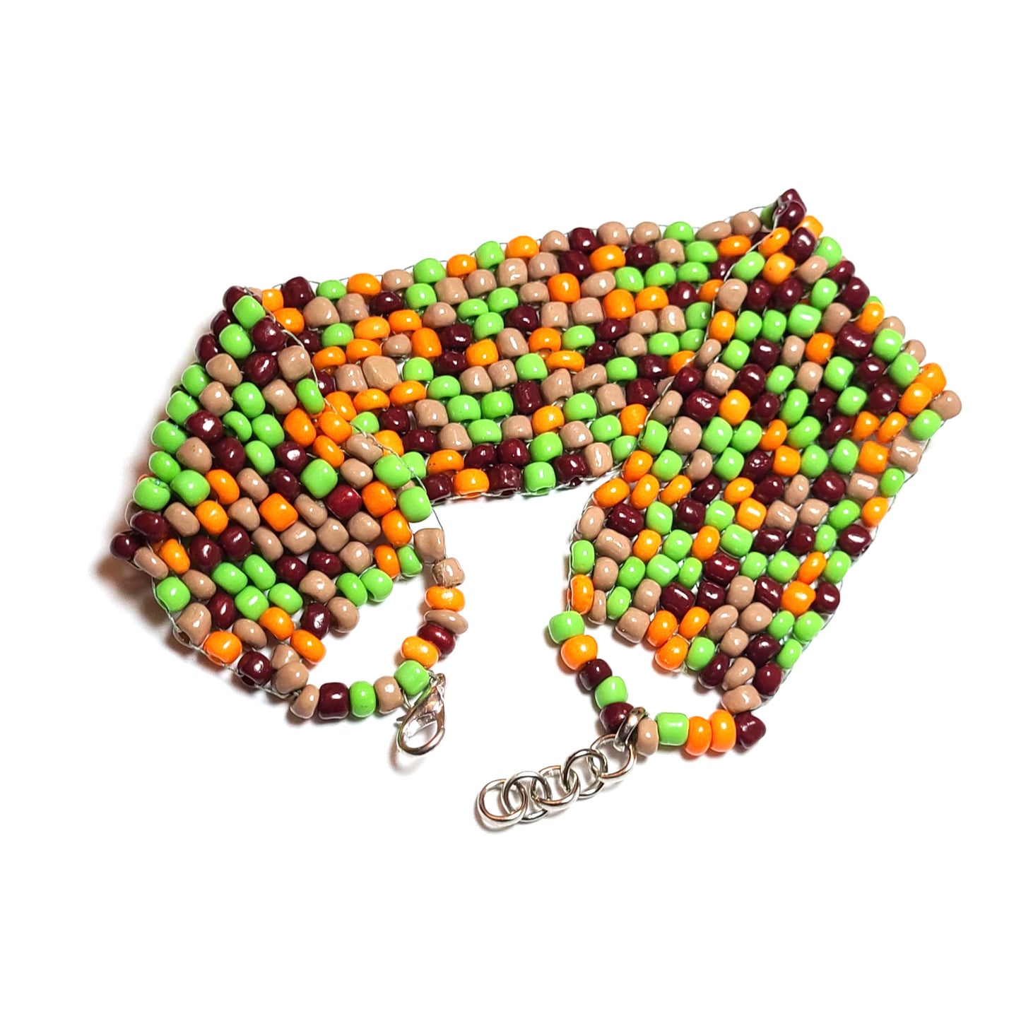 Handmade cuff bracelet/anklet beads are of random sizes and widths which give this a unique look. Bead colors are orange, beige, light green, dark red/brown with a silver colored lobster clasp and e sikver colored extender chain.