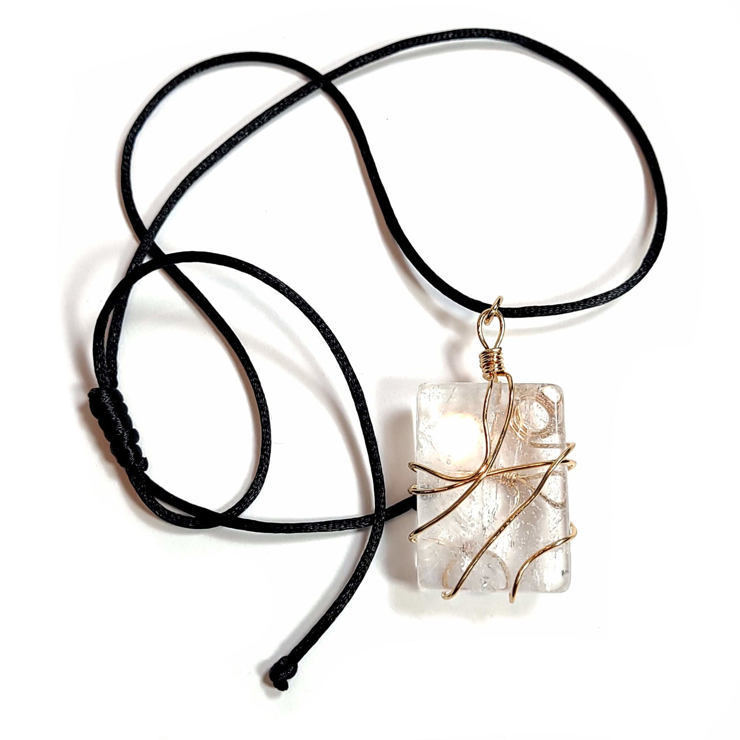 Rose gold colored wire wrapped Quartz Crystal with a black satin cord with an adjustable slip knot.