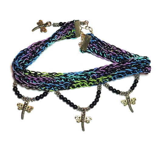 Blue, green, purple, and black dragonfly colored crocheted choker with four (4) dragonfly charms - one on the extension chain that will dangle down the back of the neck - black beads and an extension chain.