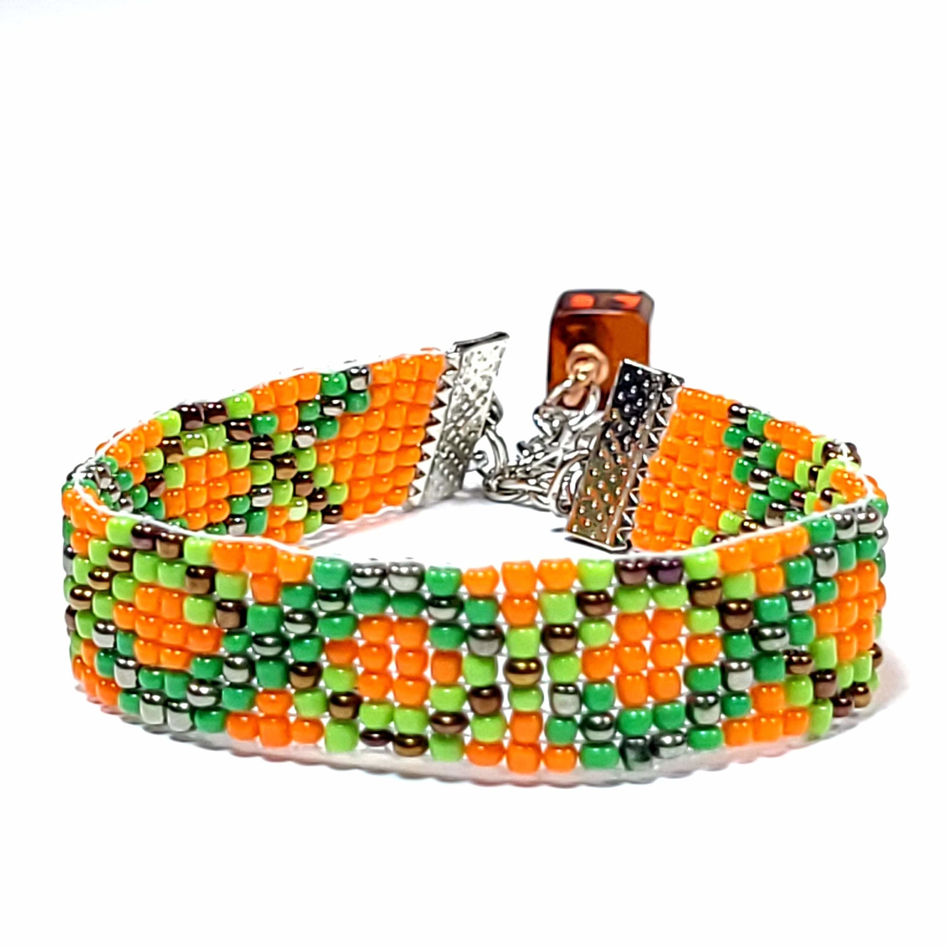 woven seed bead bracelet with orange, green, and black beads. Has a cute bead with copper wire accent on the extender.