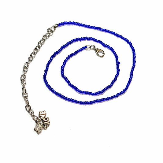 Single strand blue seed bead necklace with an extender that has 2 love charms on the end.