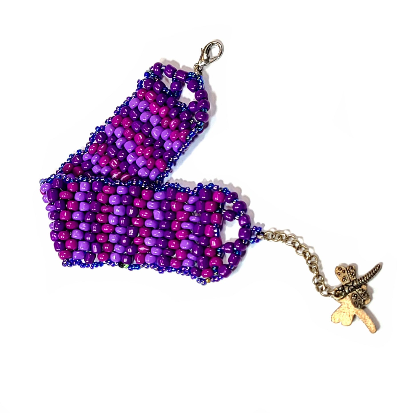 Bracelet made with pink, light purple, and dark purple beads framed by small iridescent beads. Lobster clasp with butterfly charms on an extender chain. 