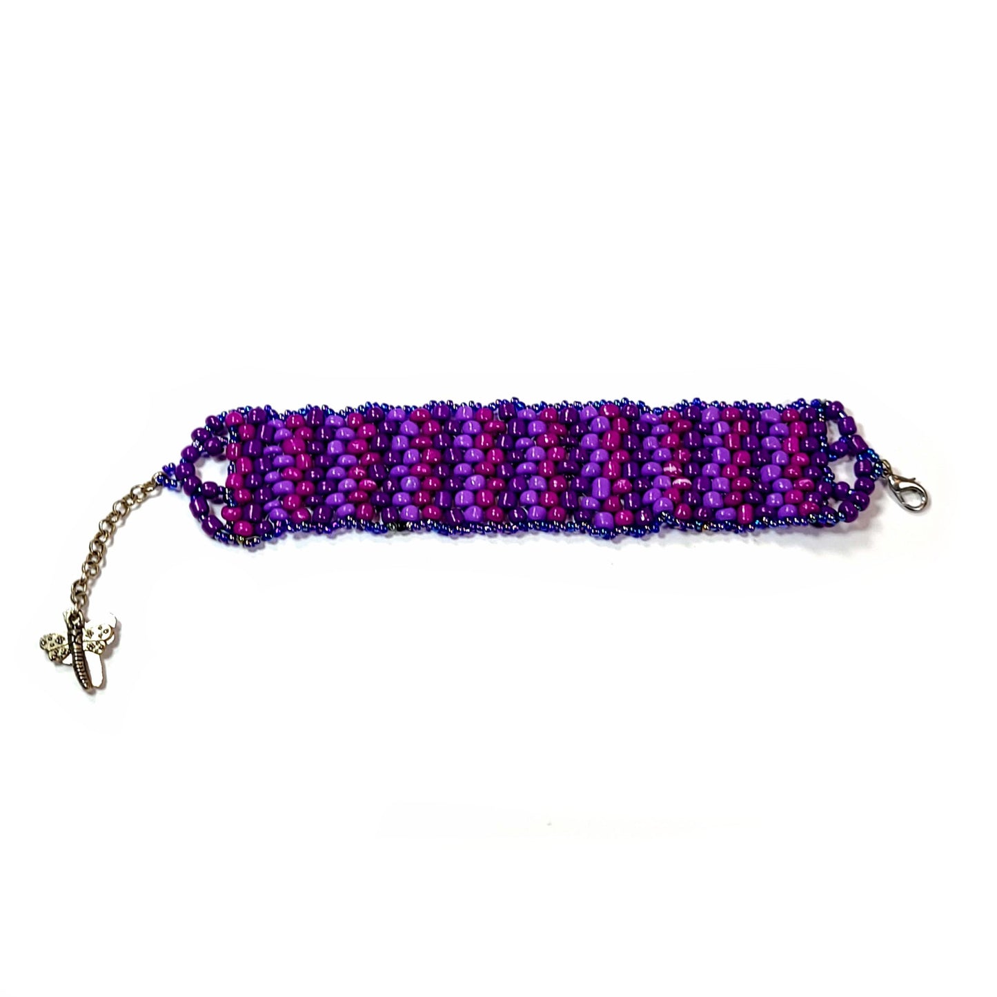 Bracelet made with pink, light purple, and dark purple beads framed by small iridescent beads. Lobster clasp with butterfly charms on an extender chain. 