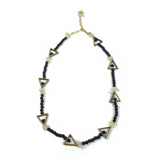 Necklace made of black lava rock beads, jadite chips, and bronze colored triangles with gold toned extender chain highlighted with a few more jadite chips. It has a lobster claw clasp.