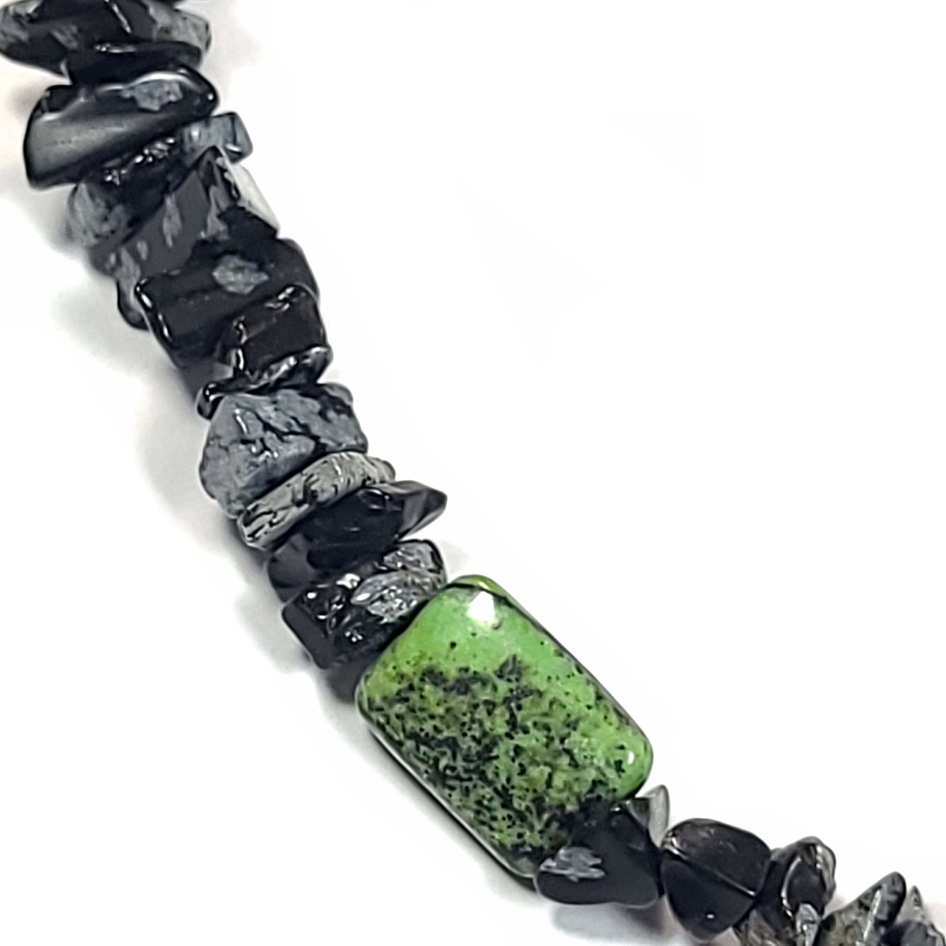 Necklace made of green Jasper rectangle pillow beads and Snowflake Obsidian chips. Silver tone extender chain .Close up view.