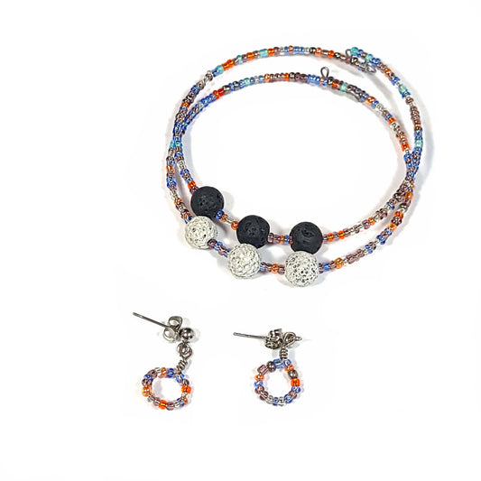 Bracelet and earring set made of multi-color seed beads in the blue and orange color range. The bracelets (2) are singular memory wire with triple lava rock center pieces. Small hoop earrings drop approximately. 