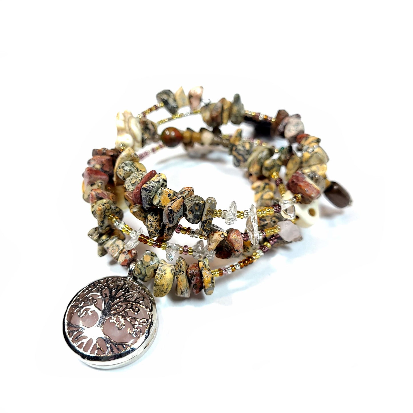 Memory wire bracelet made with multi-colored jasper chips, skull charm, quartz chips, seed beads, silver tone and semi precious stone charms.