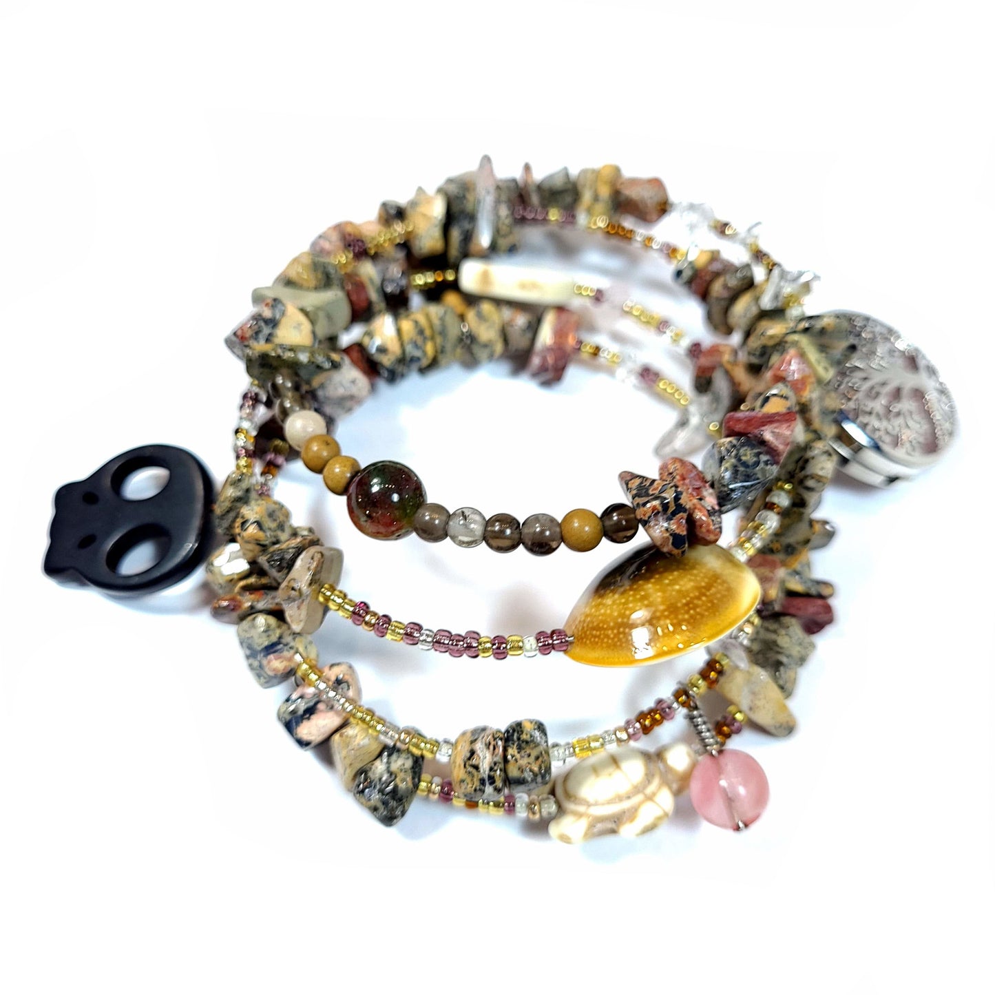 Memory wire bracelet made with multi-colored jasper chips, skull charm, quartz chips, seed beads, silver tone and semi precious stone charms.