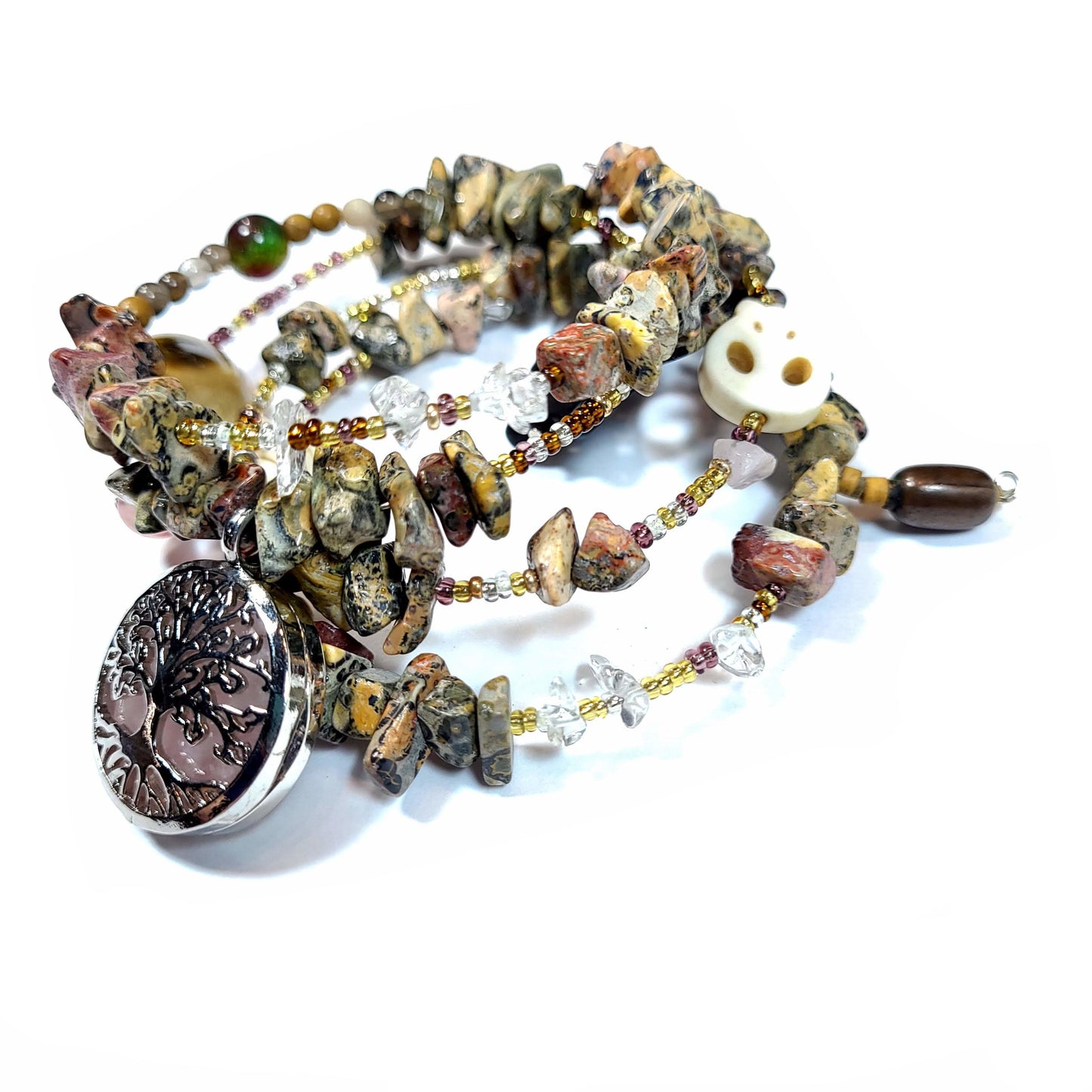 Memory wire bracelet made with multi-colored jasper chips, skull charm, quartz chips, seed beads, silver tone and semi precious stone charms.