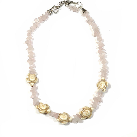 Necklace made of Rose quartz chips and Howlite turtles with silver tone end caps, extender chain and lobster claw.